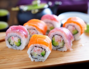 salmon and tuna sushi on a wooden tray